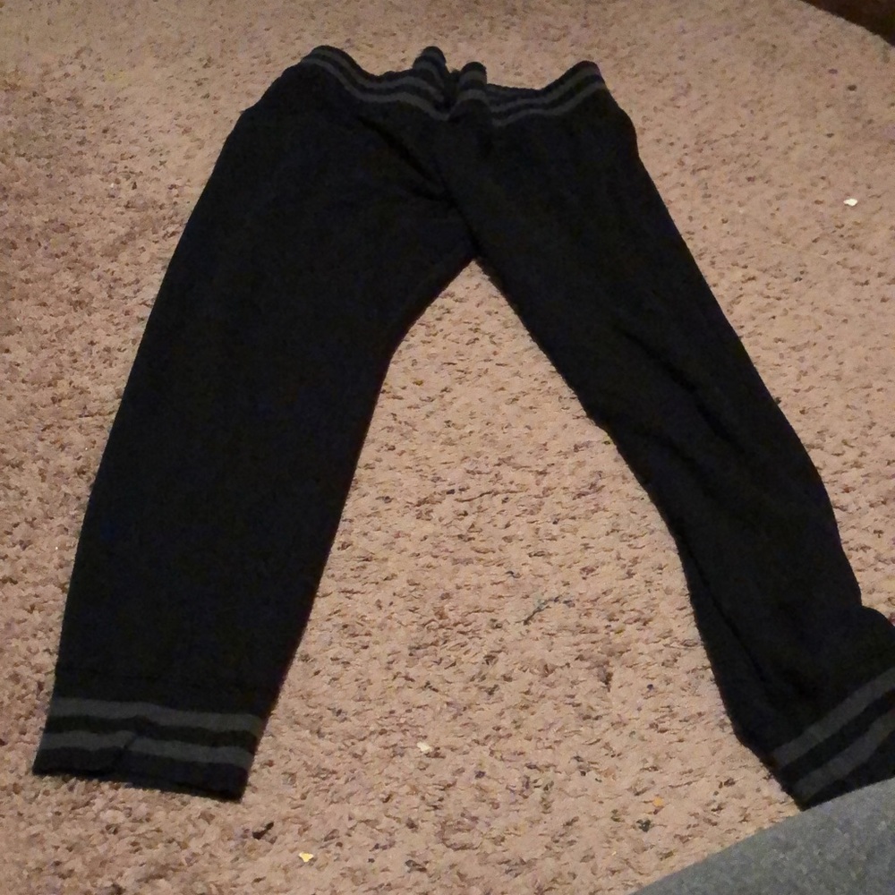 black joggers with grew stripes on the bottom